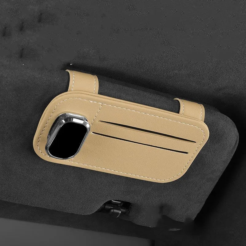 Beige cowhide leather automotive sun visor card holder with a glasses clip attached.