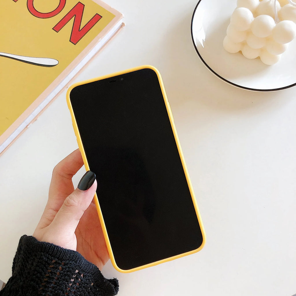 Squeeze the banana graphic on an open banana coloured IMD back cover case for iPhone.