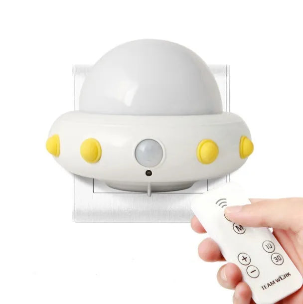 Remote control UFO shaped bedside night light in blue, pink, or white colour options.