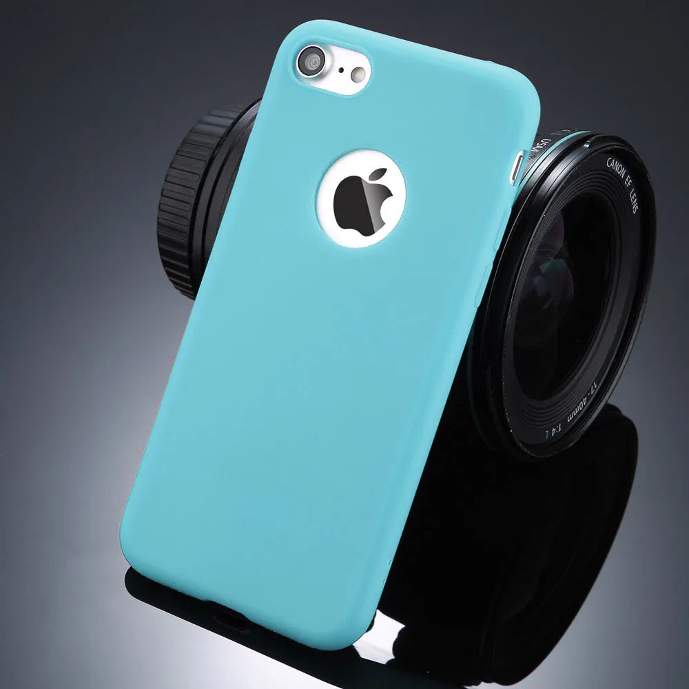 Plain soft silicone TPU phone case for iPhone in a candy colour on a table.