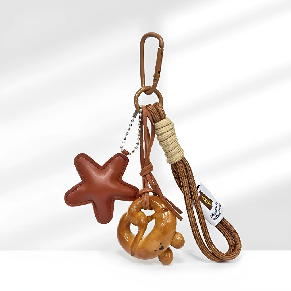 Handmade soda bread style handbag pendant with brown strap showing cartoon baked goods design
