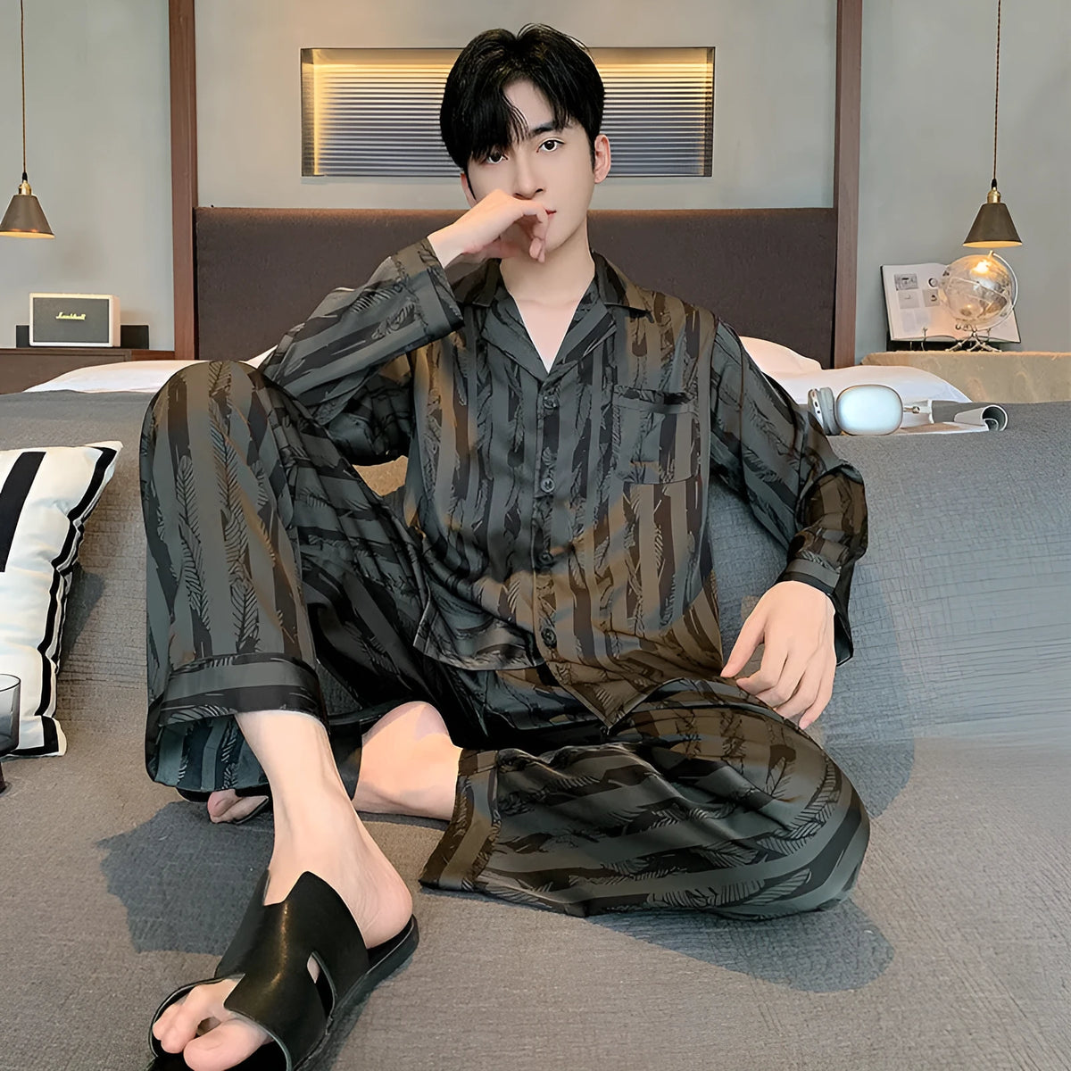 Men's black striped Ice Silk pajama set with long sleeves and trousers laid flat