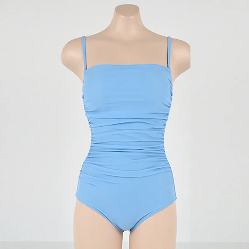 Sling style one-piece swimsuit with belted waist and pleated design in nylon fabric