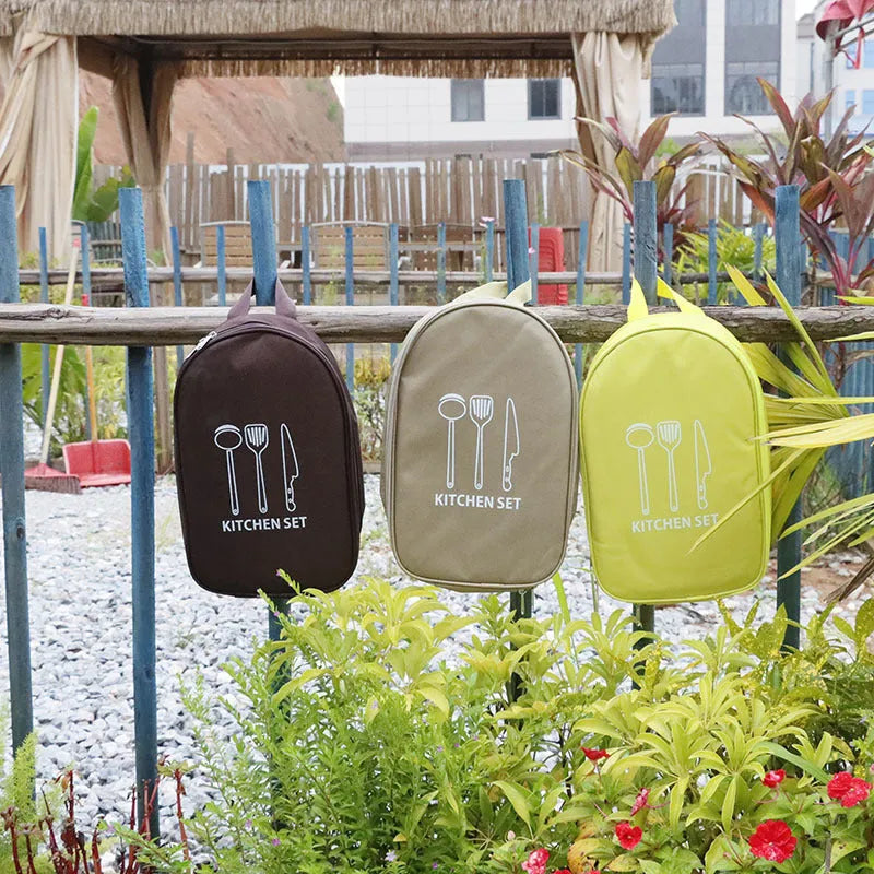 Portable picnic kitchenware storage bag containing stainless steel cutlery set for twelve persons