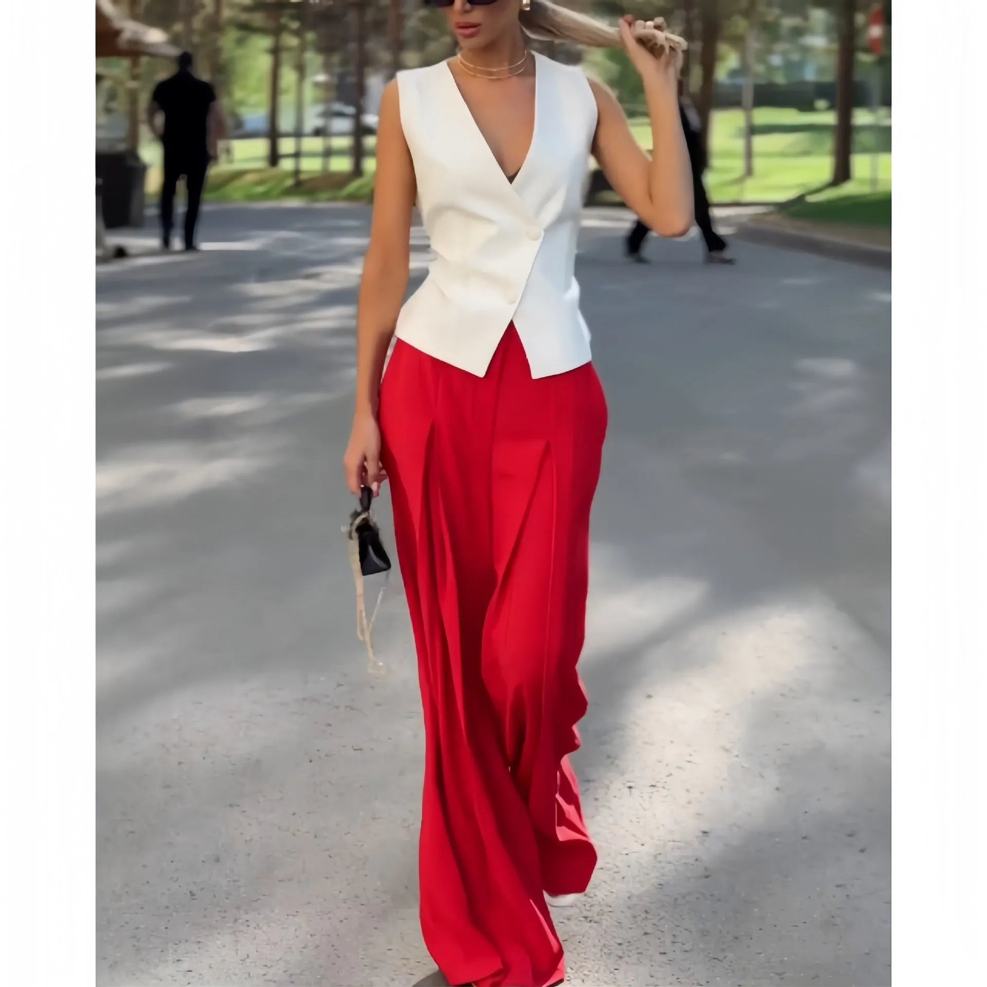 Beige women's sleeveless V-neck top and wide-leg high-waist trousers two-piece set laid flat.