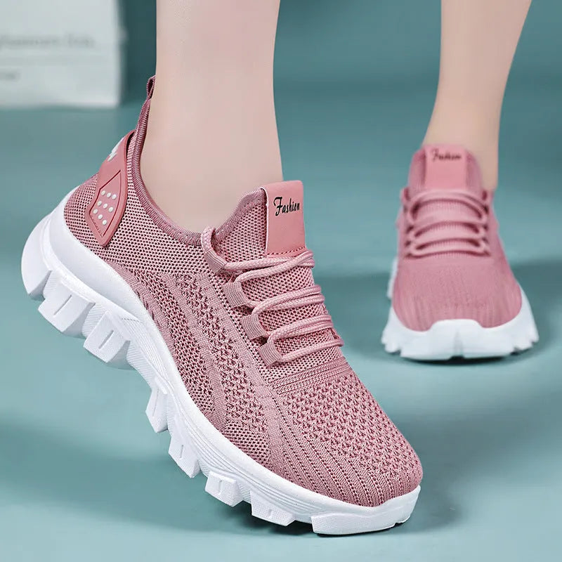 Women's white Flyknit running sneakers with thick PVC sole and lace-up front on a beige background.