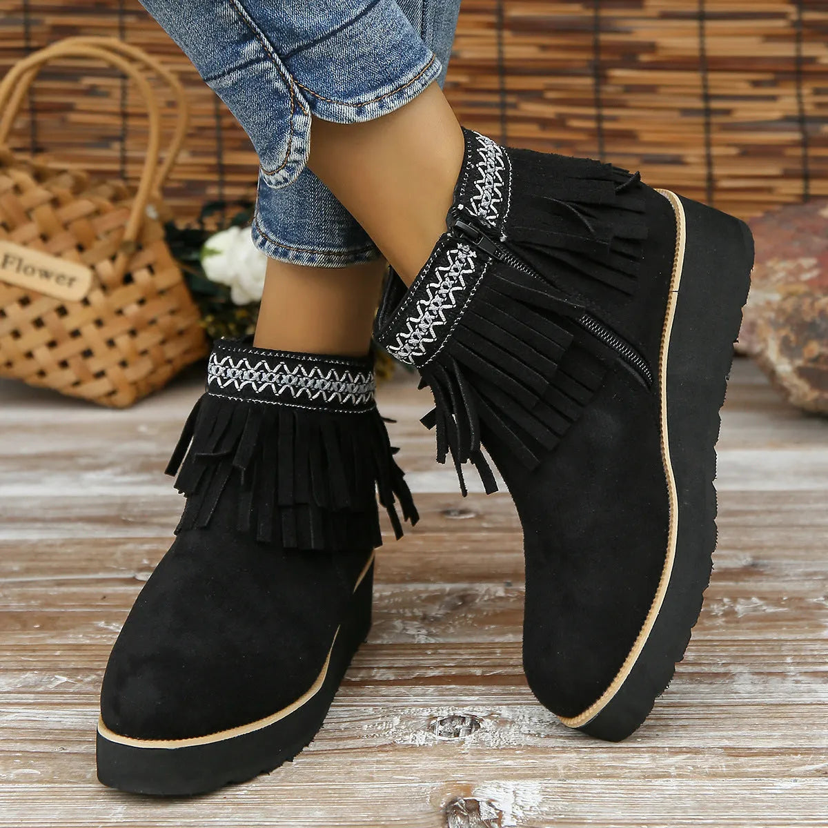 Women's black suede wedge ankle boot with side zip, tassel, and thick rubber sole.