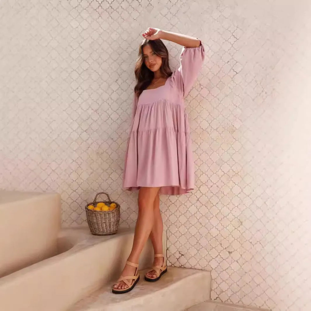 Girls orange backless dress with puff sleeves and a square collar, showing A-line skirt.