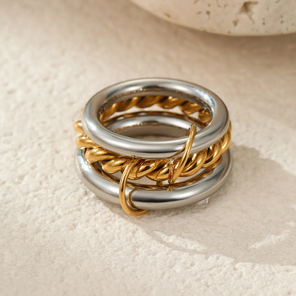 Gold plated stainless steel stackable ring for women in an exaggerated design on a hand.