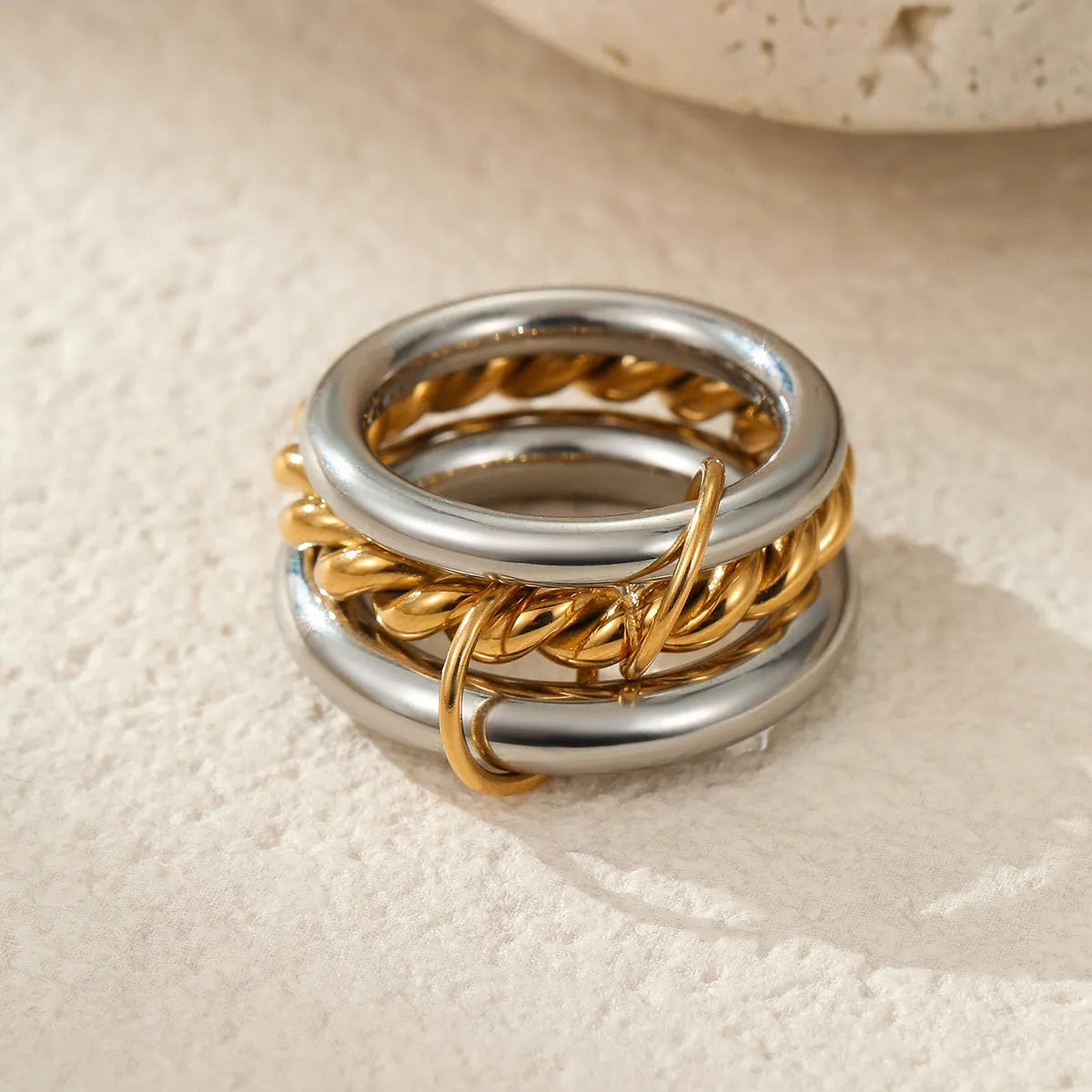 Gold plated stainless steel stackable ring for women in an exaggerated design on a hand.