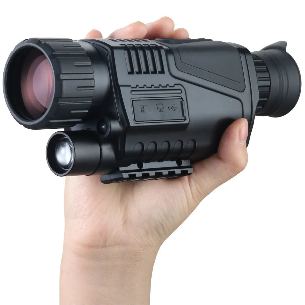 Black infrared digital night vision telescope with camera lens, rubber grip, and wrist strap on a table.