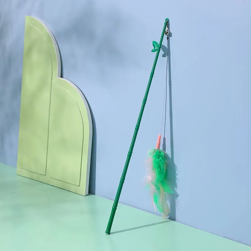 Green interactive cat feather wand toy with bell attachment and a comfortable grip handle.