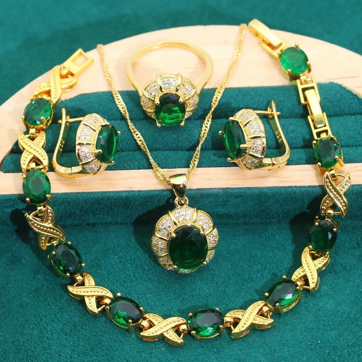 18k gold plated jewellery set with blue synthetic cubic zirconia stones, showing necklace, earrings, ring, and bracelet.