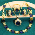 18k gold plated jewellery set with blue synthetic cubic zirconia stones, showing necklace, earrings, ring, and bracelet.