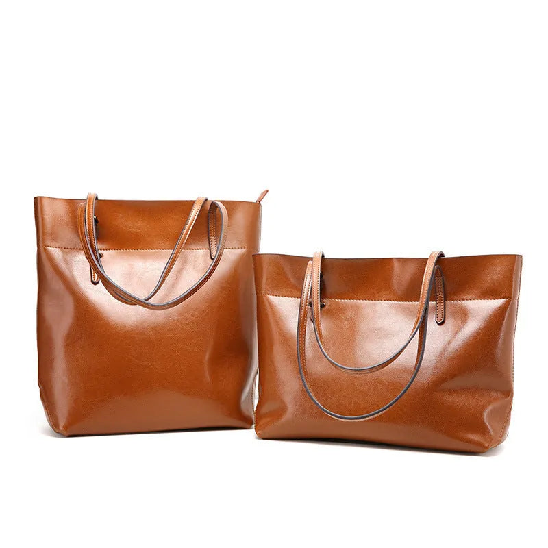 Brown waxed cowhide leather ladies crossbody handbag shown open, revealing internal organiser pockets.