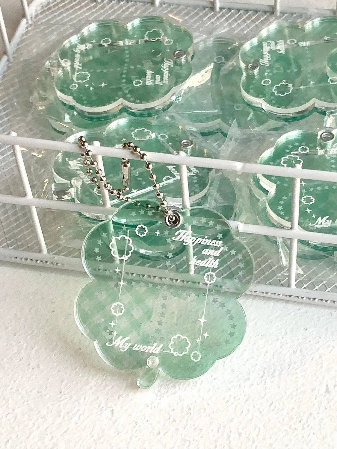 Acrylic four-leaf clover phone pendant in three colour variations