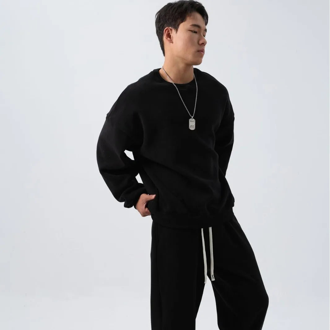 Men's polar fleece sports suit showing loose long sleeve coat and padded trousers in army green.