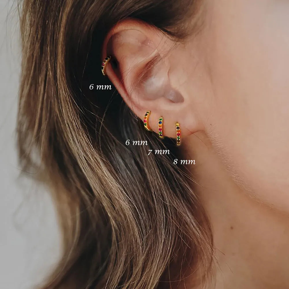 Set of three pairs of round zircon stud earrings showing gold colour, rose gold colour, and silver colour finishes.