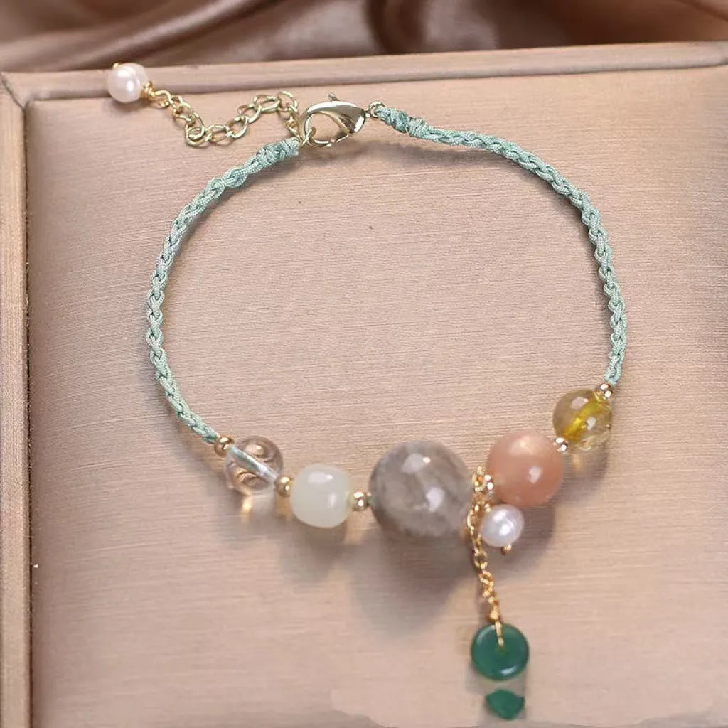 Hand-woven crystal and sequin bracelet with metal buckle clasp in red, blue, or green.