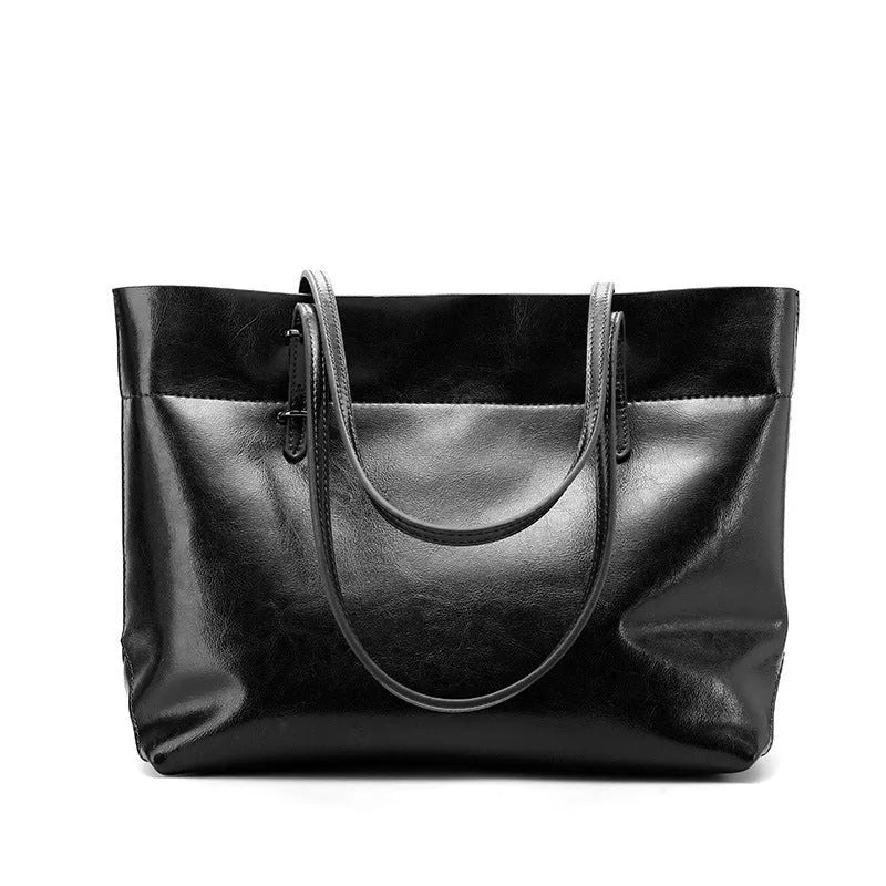 Brown waxed cowhide leather ladies crossbody handbag shown open, revealing internal organiser pockets.