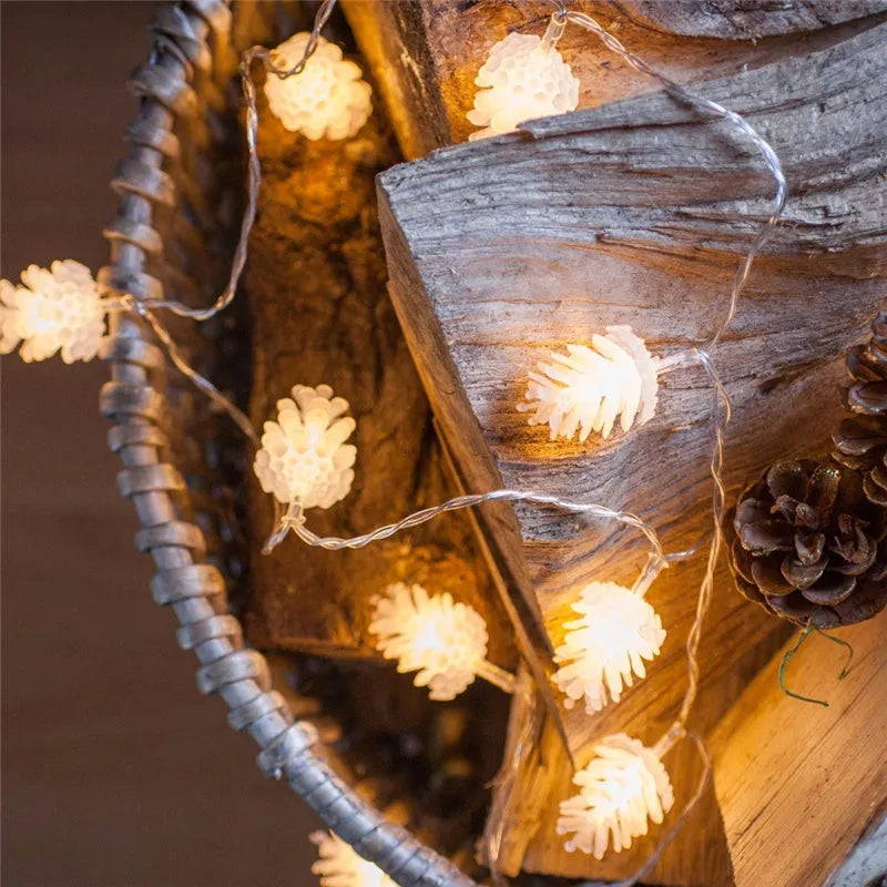 Warm white LED pine cone decorative light string powered by two AA batteries.