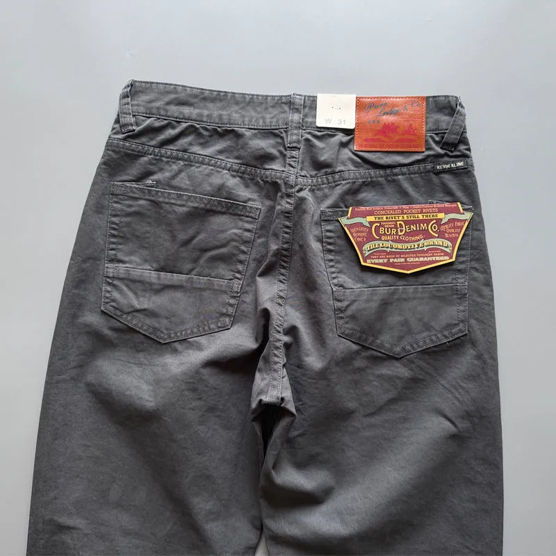 Men's straight leg cotton casual trousers in grey, shown on a model.