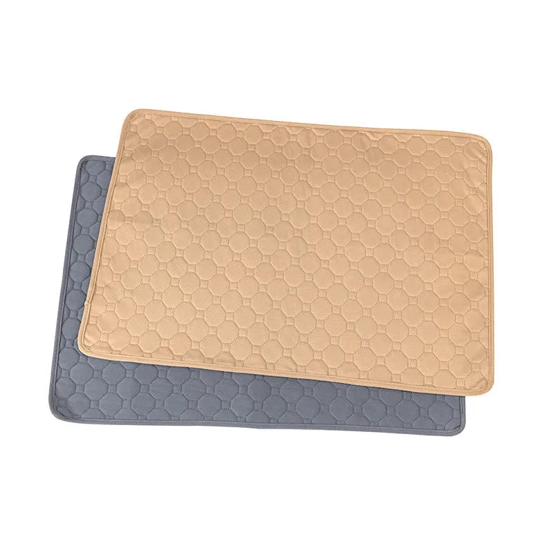 Two neutral-coloured washable dog pee pads, one tan and one grey, showing textured fabric surface.