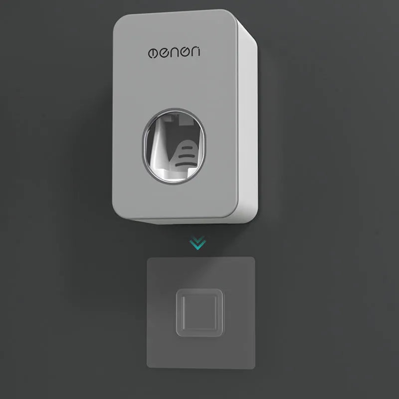 White and grey wall mounted automatic toothpaste dispenser with toothbrush rack, shown in grey, green and pink colour options.