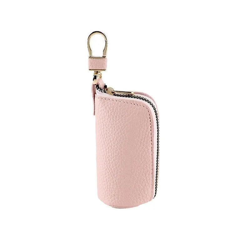 Simple black PU leather zipper key ring for car keys on a grey background.