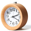 Solid beech wood silent snooze alarm clock showing wooden case, glass mirror face, and 9.5cm diameter