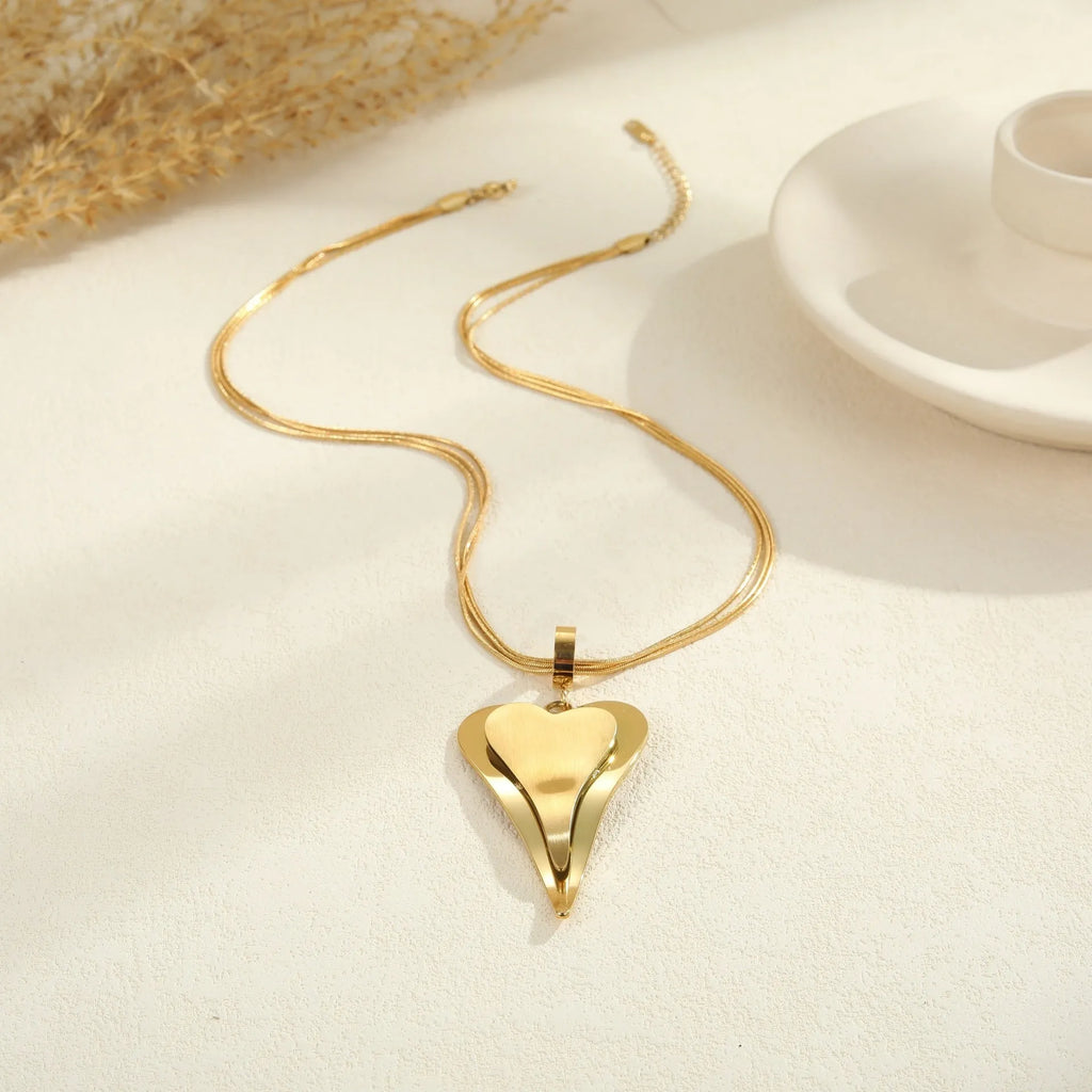 Geometric double-heart pendant on a stainless steel snake bones chain necklace for women, shown in gold and steel finishes.