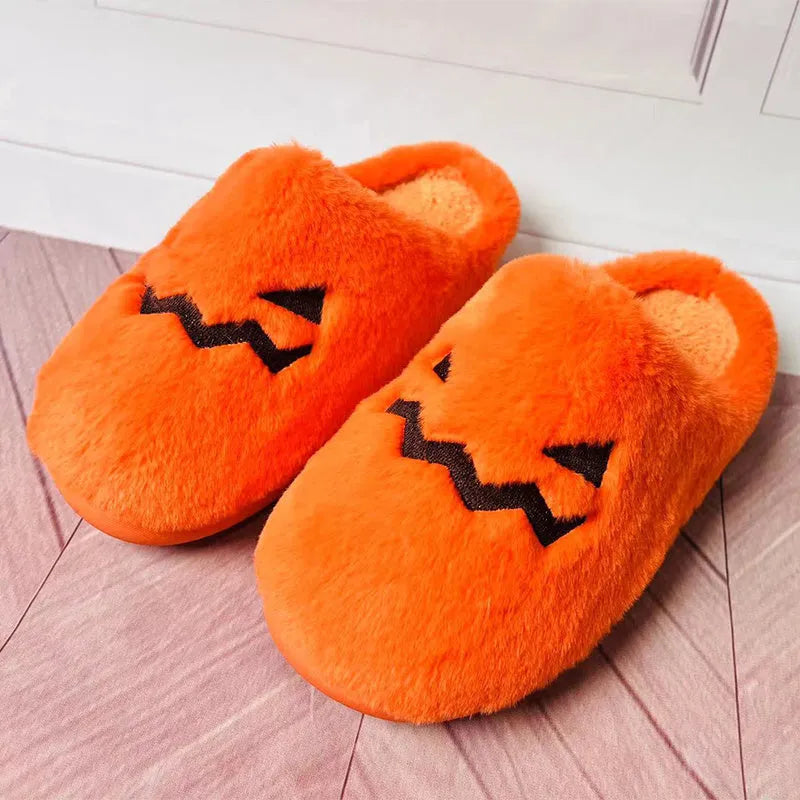 Orange Halloween pumpkin-themed plush slippers with a coral velvet upper and non-slip sole.