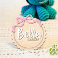 Square wooden baby room ornament with customised name engraving, shown in two size options.