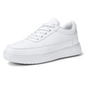 Women's white leather lace-up casual flat shoes on a light background.