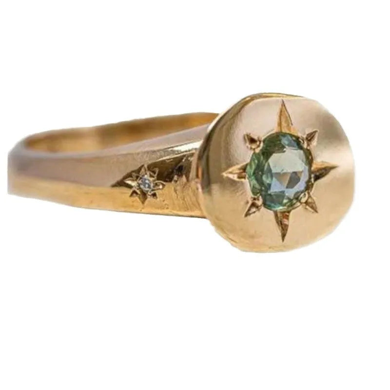 Gold-coloured star-shaped ring with oval zircon detail and adjustable opening