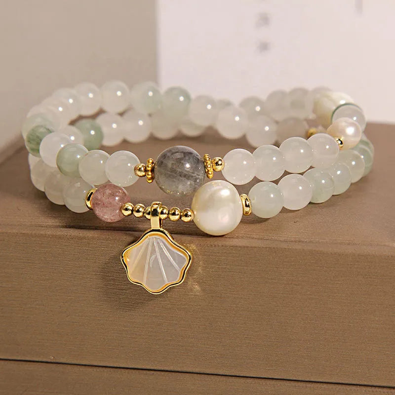 Emerald green crystal bracelet with ginkgo leaf pendant and gold-plated rhinestone details
