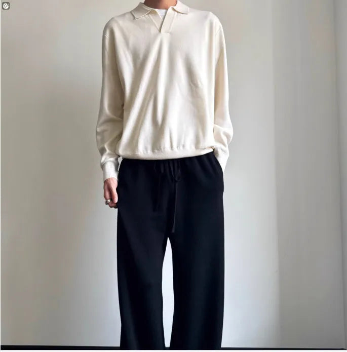 Man wearing a milky white pure wool polo sweater with a lapel collar in a loose fit.