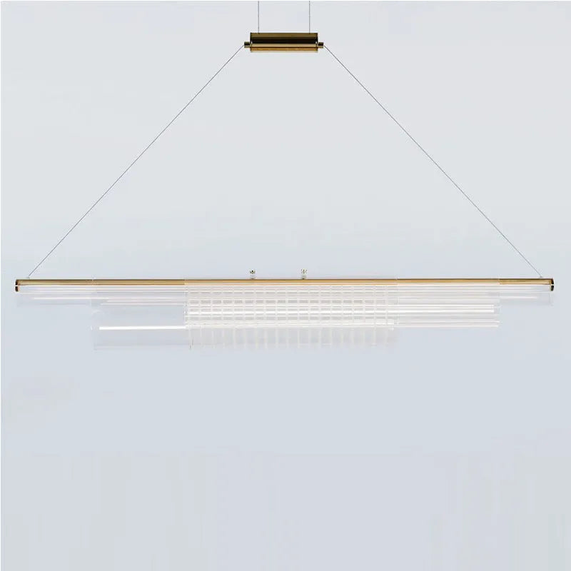 Modern clear glass and iron LED pendant light hanging at three different lengths.