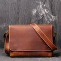 Vintage brown leather men's messenger bag with shoulder strap showing internal organiser pockets.
