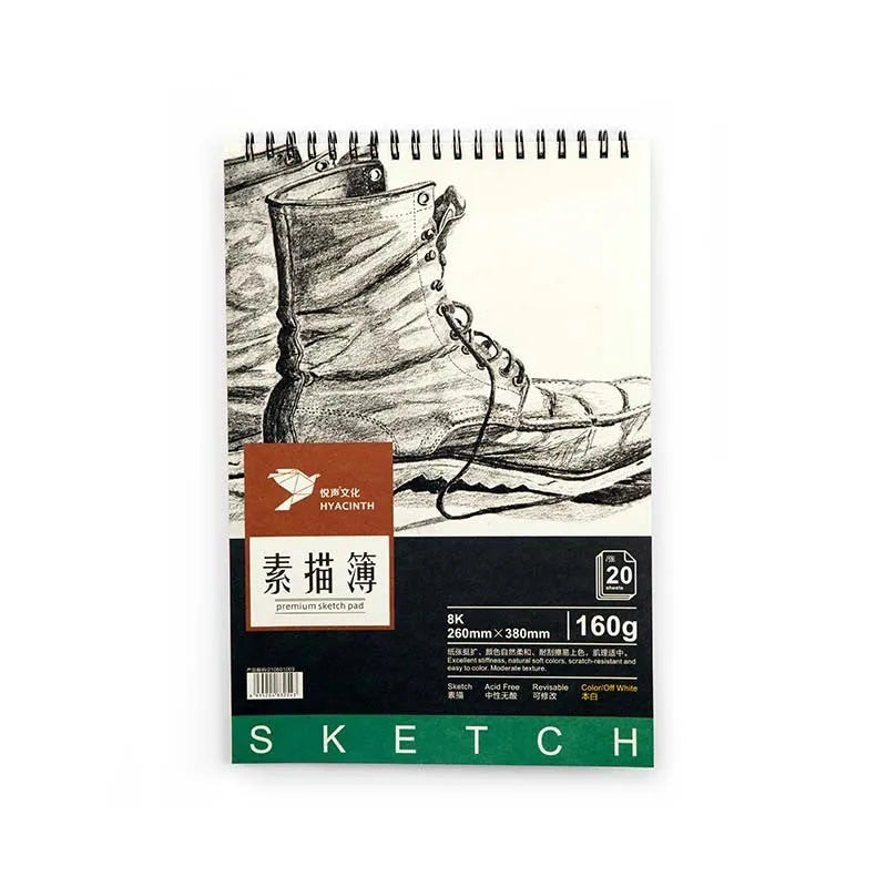 A4 sketchbook with coil binding lying flat open, showing blank heavyweight drawing paper.