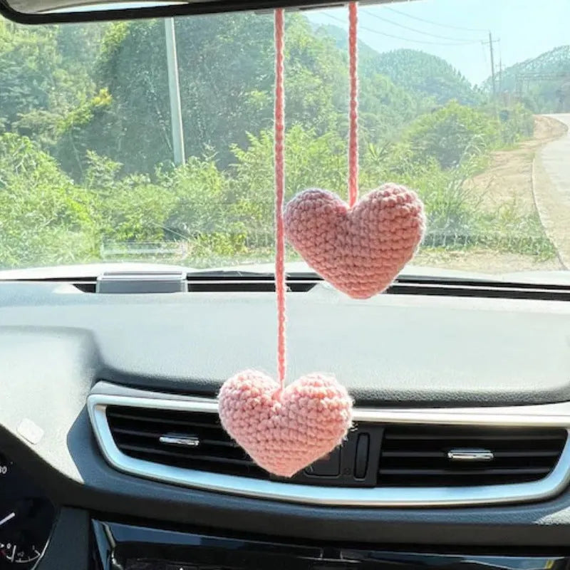 Green and white knitted wool car plant decoration basket with white hanging cord.