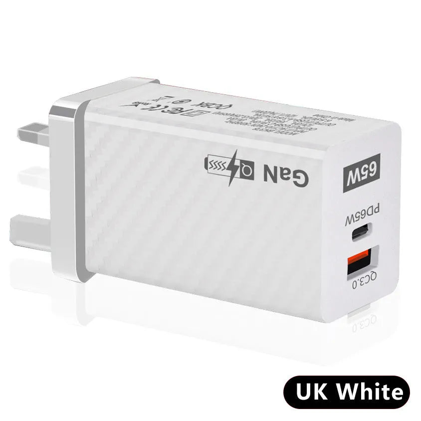 White GaN 65W universal laptop charger with USB PD port showing compact dimensions