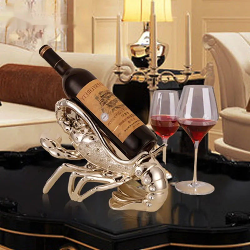 Lobster-shaped wine rack ornament in metallic rose gold or silver finish on display surface