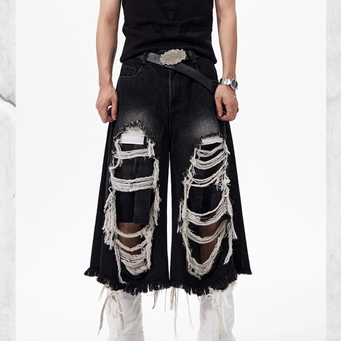 Black women's cropped wide-leg jeans with ripped patch details on a mid-high waist.