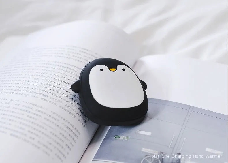USB rechargeable electric hand warmer with penguin polar bear design showing front and back heating surfaces