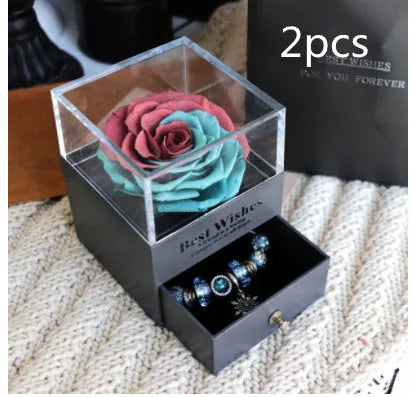 Glass eternal flower jewellery box with preserved roses and carnations inside measuring 8.5cm square
