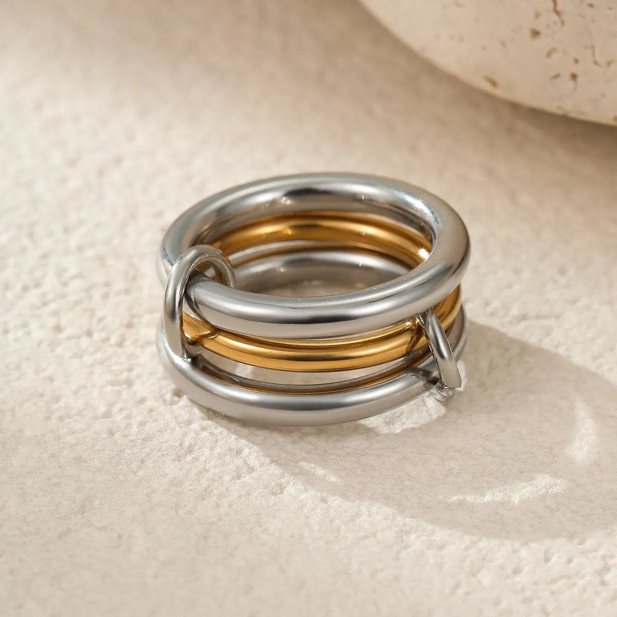 Gold plated stainless steel stackable ring for women in an exaggerated design on a hand.