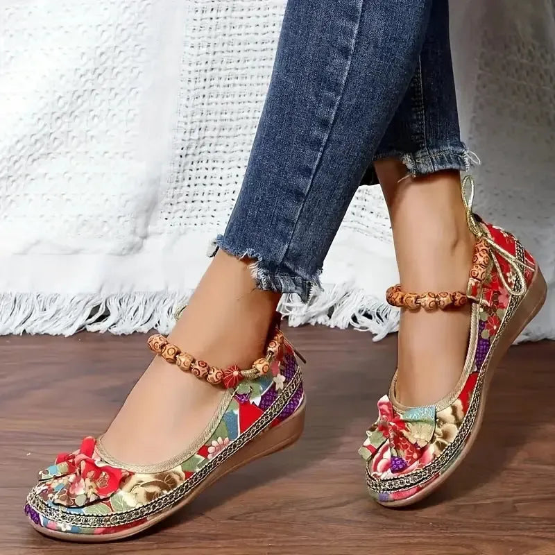Women's black ethnic style platform sandals with cloth upper and elastic band fastening.