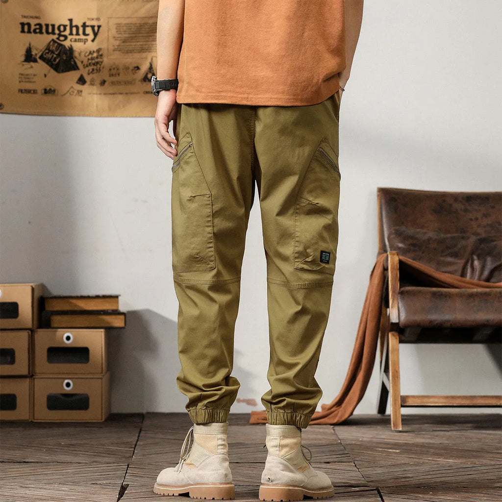 Men's khaki cotton harem pants with tapered ankle band and zip placket front view