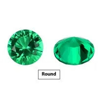 Cultivated emerald loose gemstones in round and fancy cut shapes on a dark background.